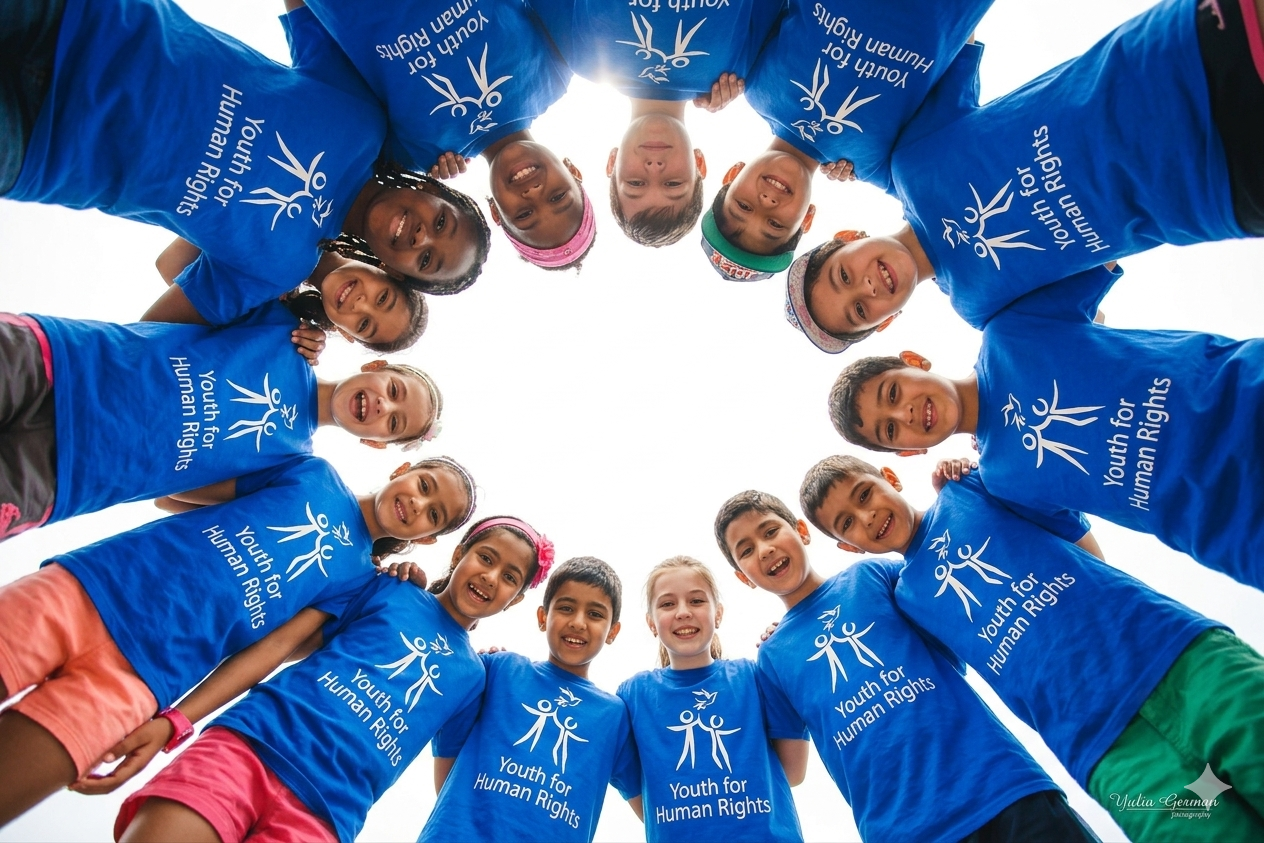Diverse group of children in a circle wearing Youth for Human Rights shirts