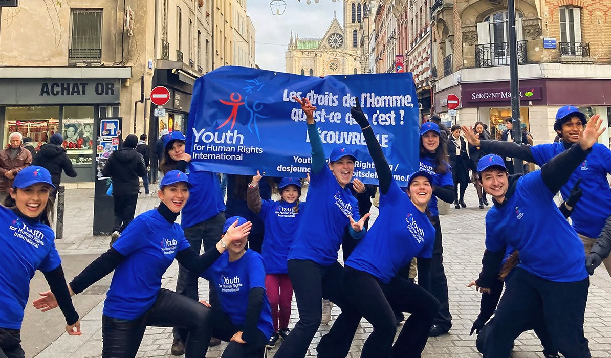 Diverse young people smiling with human rights posters